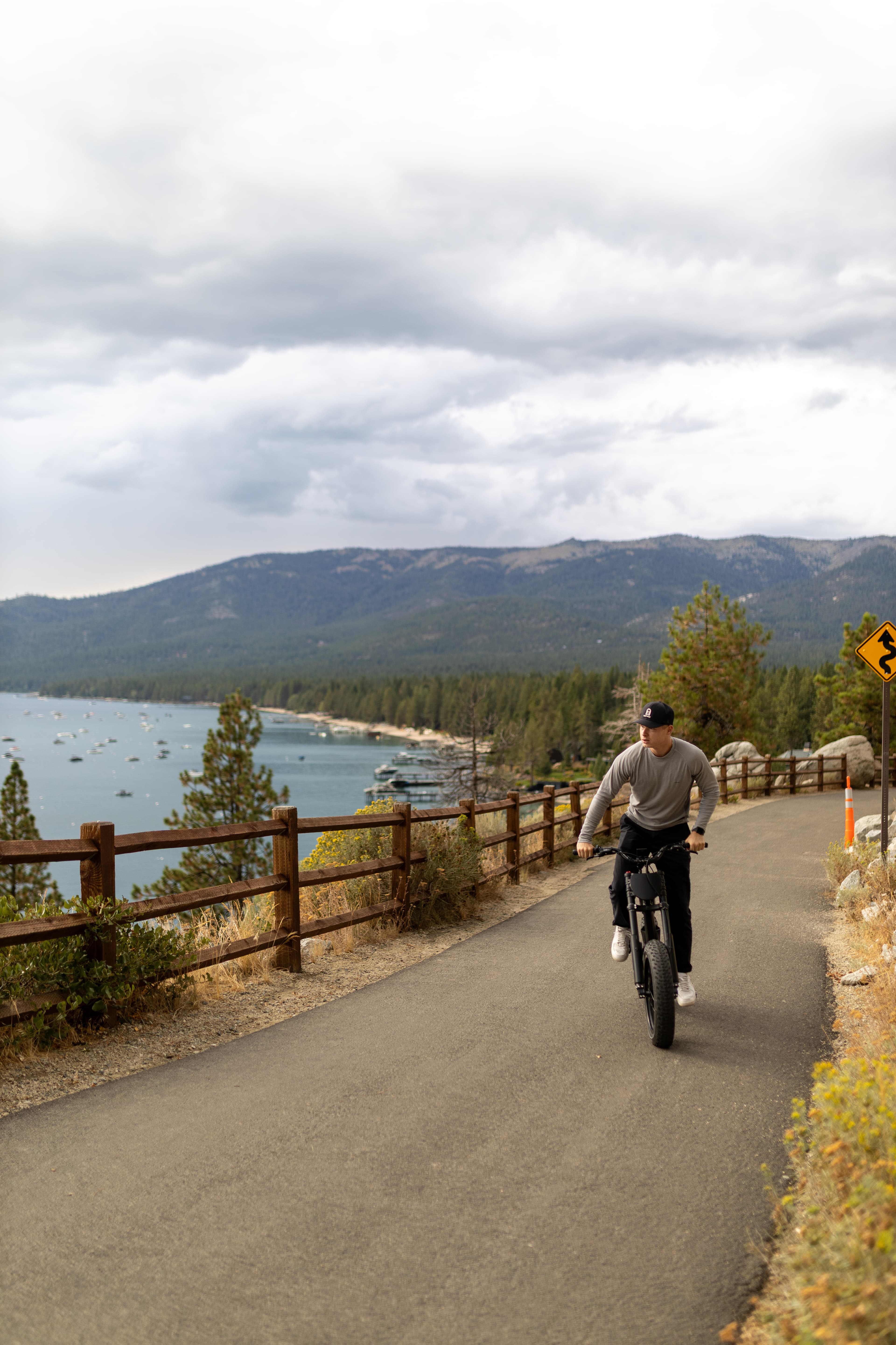 Rider on Surfline SL on a coastal boardwalk path wearing a helmet
