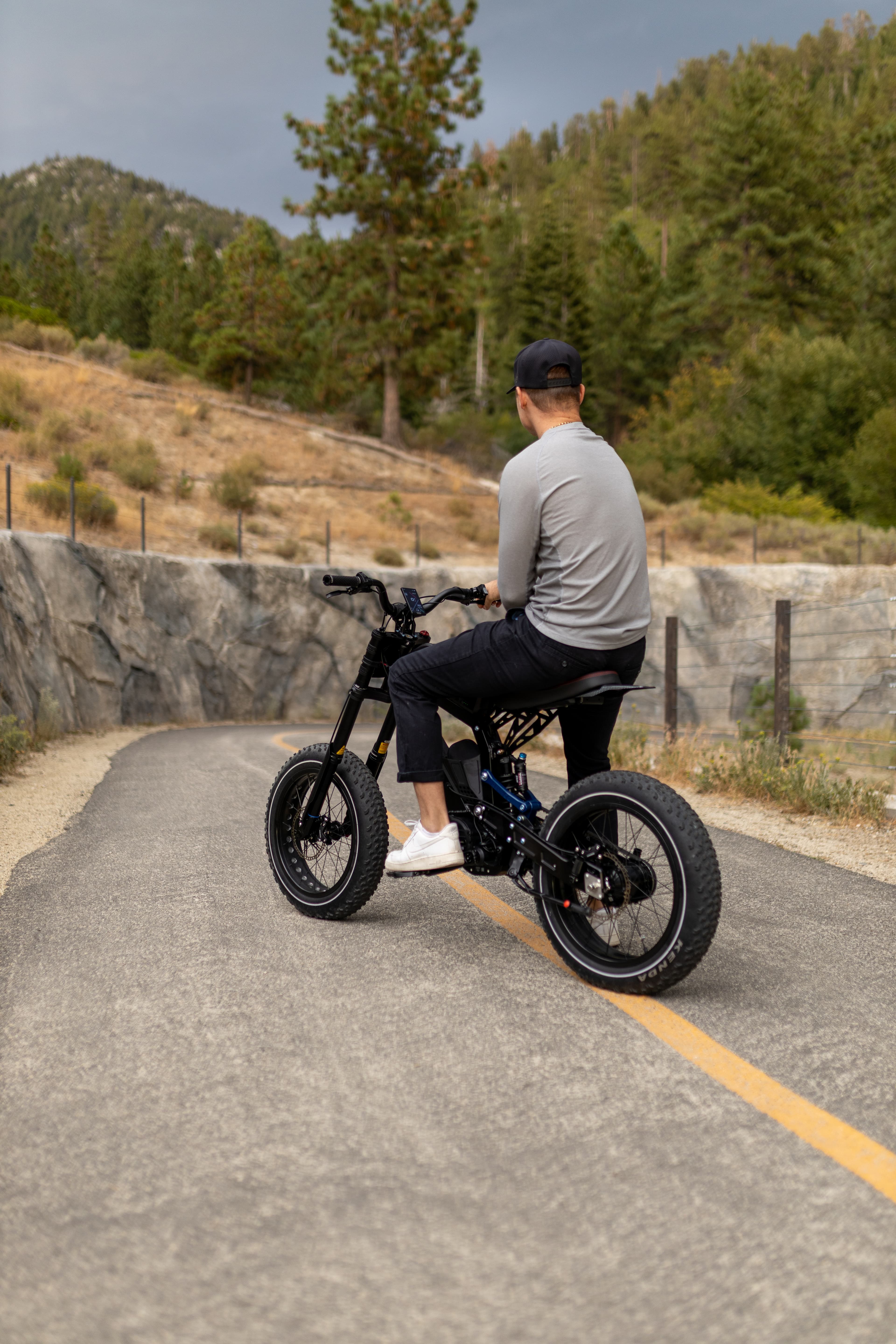Rider on Surfline Auto on a coastal boardwalk path wearing a helmet